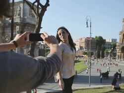 Tourist couple taking a photograph in front of the Coliseum Stock Footage