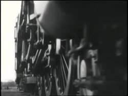 A conductor powers a train down the tracks. News Clip