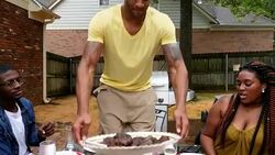 MS ZO PAN Man serving platter of hamburgers during dinner party in backyard Stock Footage