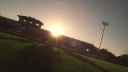Three defenders follow an offensive player while he dribbles a soccer ball. Stock Footage