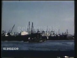 1950: RUBBER LATEX SHIPPING: COLOR: WS Cargo ship moving in harbor. WS 'Farrell Line' dock, warehouse. VS Shipment of packaged rubber latex bales in net being unloaded down to dock, dock workers. Instructional Video