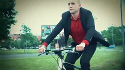 Late 20's businessman riding a bike to work. Stock Footage
