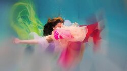 Caucasian woman in dress swimming under water Stock Footage