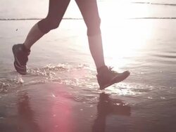 Jogging at the beach Stock Footage