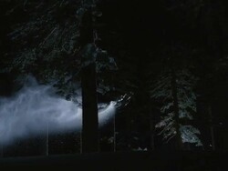 WS SLO MO PAN Snowmobile jumping in snow covered forest / Mammoth Lakes, California, USA Stock Footage