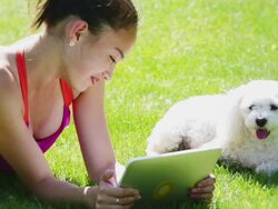 Young girl and pet using tablet Stock Footage