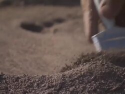 ECU Archaeologist brushing sand off artifact / Tanzania Stock Footage