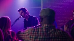 Medium dolly shot of lead guitar through party crowd clapping rhythm Stock Footage