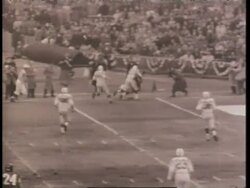 Sports fans cheer as the Baltimore Colts play against the New York Giants in the National Football League championship game. News Clip