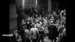 1950: EBBETS FIELD: NIGHT GAME: EXT Ebbets Field w/ lights on, people, fans walking toward & into stadium. HA TD People entering baseball stadium, crowded area w/ brick columns. TU WS Back of flood lights top of stadium, lights on.  Brooklyn Dodgers. Instructional Video