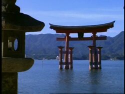 MS view across water to statue and floating gate of the Itsukushishima shrine, Miya-Jima island, Japan Stock Footage
