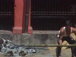 MS PAN Man stoking  fire with  long stick AUDIO / Kathmandu, Central Region, Nepal Stock Footage