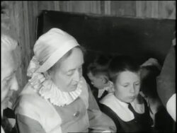 A Pilgrim father carves and serves turkey to his family at the dinner table in 1621. News Clip