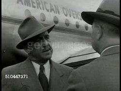 1949: SWEDEN OPINION: DRAMATIZATION: EXT MS Swedish man talking by 'American Overseas...' airplane to another man, 'They still think they can be neutral when the war comes...' Bromma Airport, Stockholm. Instructional Video