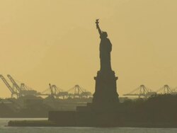 Statue of Liberty, cranes in background, New York City, USA Stock Footage