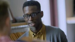 Clothing store employee offers customer advice and assistance Stock Footage