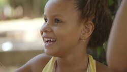 Young Brazilian girls play with ball on string in public park Stock Footage