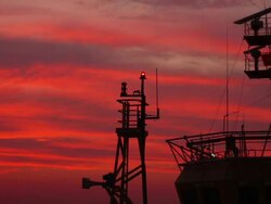 oil drill platform sailing in sunset Stock Footage