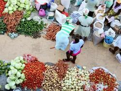 WS HA SLO MO Shot over African market street vendors selling fresh vegetables and fruits / Santiago, Cape Verde Stock Footage