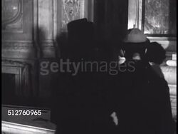 1940: VATICAN CITY: SAINT PETER'S BASILICA: GROTTOES: Statue of Saint Andrew (brother of St. Peter), people walking to grottoes stairs, woman walking in crypts hallway, fresco of St. Peter on inverted Latin cross, Instructional Video