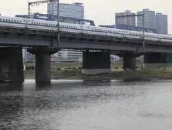 MS Bullet train shinkansen passing through Iron bridge / Tamagawa, Tokyo, Japan Stock Footage