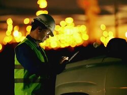 Engineer using tablet at industrial, oil or gas plant. Stock Footage