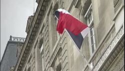 The French flag waves above the entrance of a government building in Paris. Stock Footage