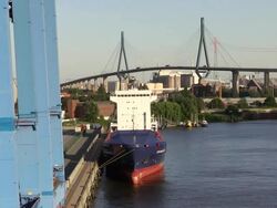 MS Shot of container ship for container terminal with Kohlbrand Bridge in harbour / Hamburg, Germany Stock Footage