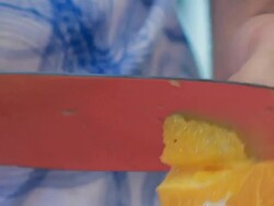 Cutting an orange on a cutting board with a sharp knife Stock Footage