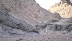 A group of  men walk through the ruinous city of Shenshef in Egypt. Stock Footage