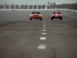 WS Two racecars coming out of turn on racetrack and driving toward camera / Long Pond, Pennsylvania, USA Stock Footage