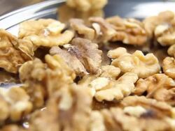 Walnuts on metal plate - loopable, HD Stock Footage