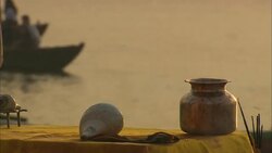 A Hindu removes seashells and an urn from an altar near the Ganges after celebrating Diwali. Stock Footage