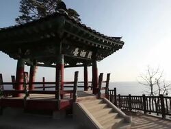 MS POV Shot of yisangdae Gazebo in Naksansa Temple at sunrise / Yangyanggun, Gangwondo, South Korea Stock Footage
