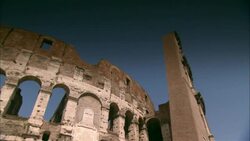 A crumbling roofline curves above the arched windows of the Colosseum in Rome, Italy. Stock Footage