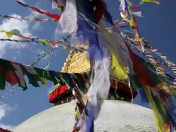 Prayer flags flying from the  Boudhanath Stupa, a place of holy worship, Kathmandu, Nepal, Asia Stock Footage
