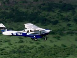 MS AERIAL ZO TS Shot of Light aircraft flying over with forest / iSimangaliso Wetland Park, Kwazulu Natal, South Africa Stock Footage