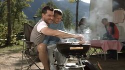 HD DOLLY: Father And Son Grilling Meat On Barbecue Stock Footage