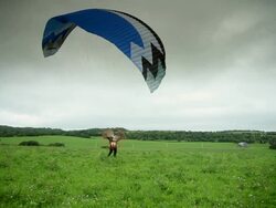 A paramotor flying in a cloudy sky Stock Footage