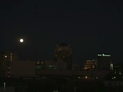 MS Shot of Montgomery city skyline at night with full moon overhead / Montgomery, Alabama, United States Stock Footage
