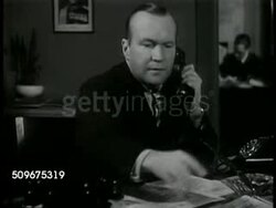 1944: STOCKHOLM, SWEDEN: DRAMATIZATION: 'Swedish Press man' sitting at desk looking over papers, calling Berlin associate. Associate talking about what's happening in Berlin (Swedish), holding phone receiver away from body, SOT bomb falling. Instructional Video