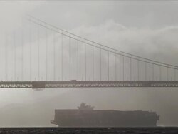 Container ship enters San Francisco Bay beneath Golden Gate Bridge Stock Footage