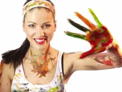 girl paints handprint at camera Stock Footage