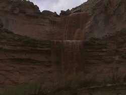 Low Angle static - Muddy water flows from steep canyon walls / Grand Canyon, USA Stock Footage