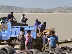 MS Men loading large clay pots on truck on Ayeyarwadi river / Bagan, Mandalay Division, Myanmar Stock Footage