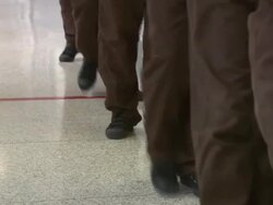 Young Rikers Island detainees walk in hallway Stock Footage