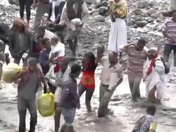 People crossing river after bridge collapse Stock Footage