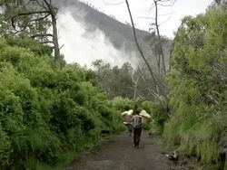WS Man carrying sulfur from the mining at the ijen volcano / Ijen, Java, Indonesia Stock Footage