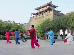 WS LA Asian women performing exercise with fans in city wall Park/xian,shaanxi,China Stock Footage