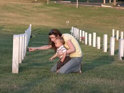 Young woman and son visit grave HD Stock Footage
